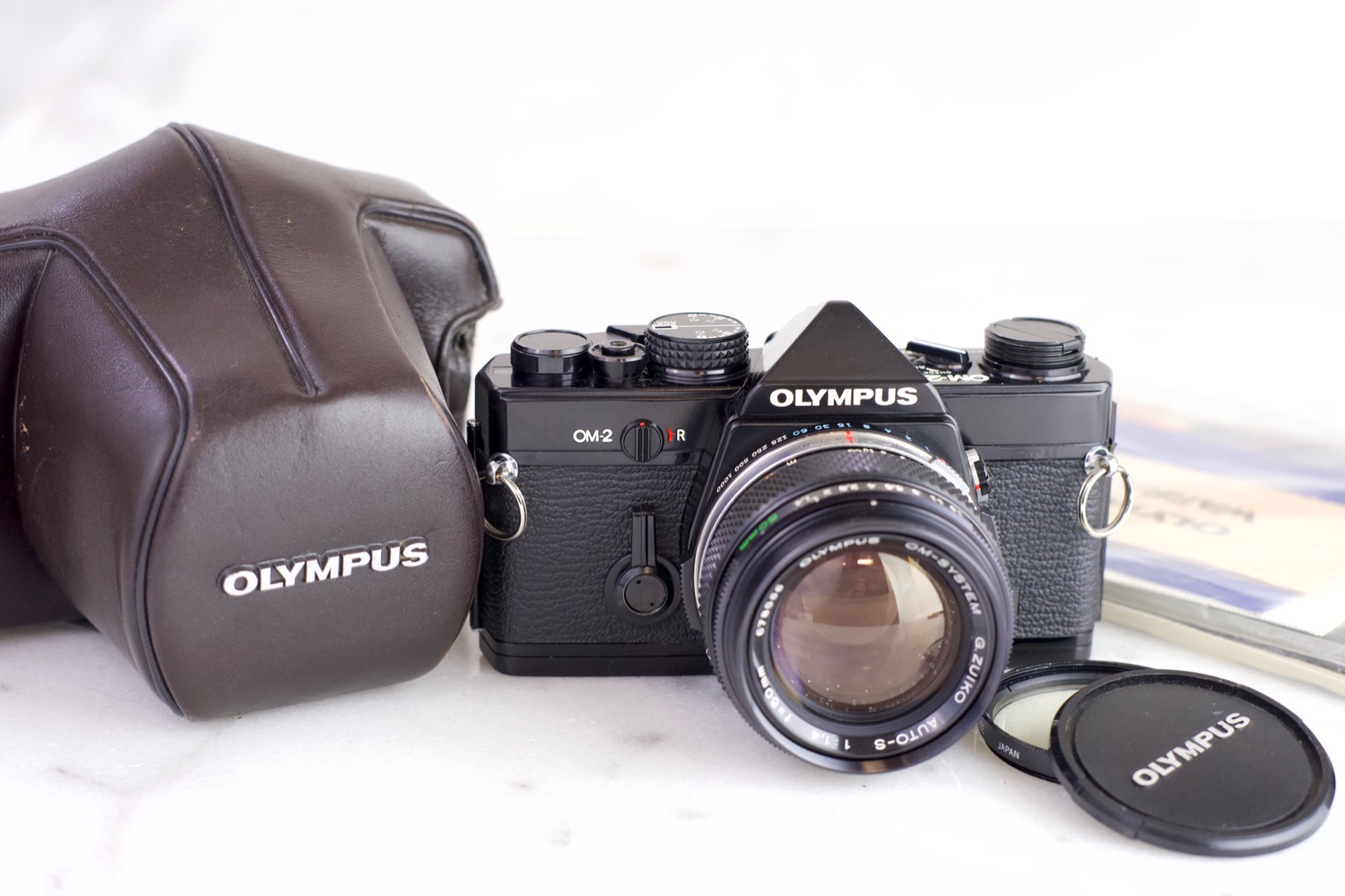 Olympus OM-2 35mm Film SLR Camera with Olympus Zuiko 50mm F 1.4 Fast Prime  Lens, Lens Cap, UV Filter, Manual, Case, New Batteries — F Stop Cameras